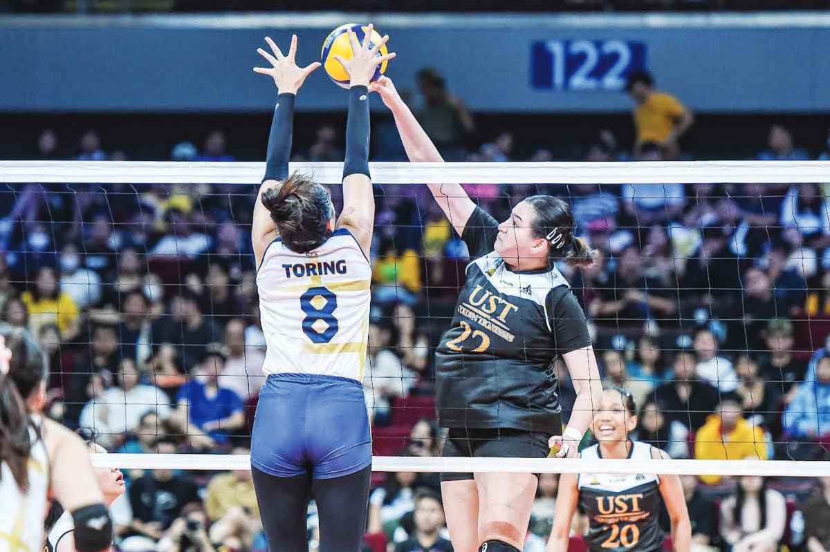 University of Santo Tomas Golden Tigresses’ Bianca Plaza attempts to score against the defense of National University Lady Bulldogs’ Sheena Toring. (UAAP photo)