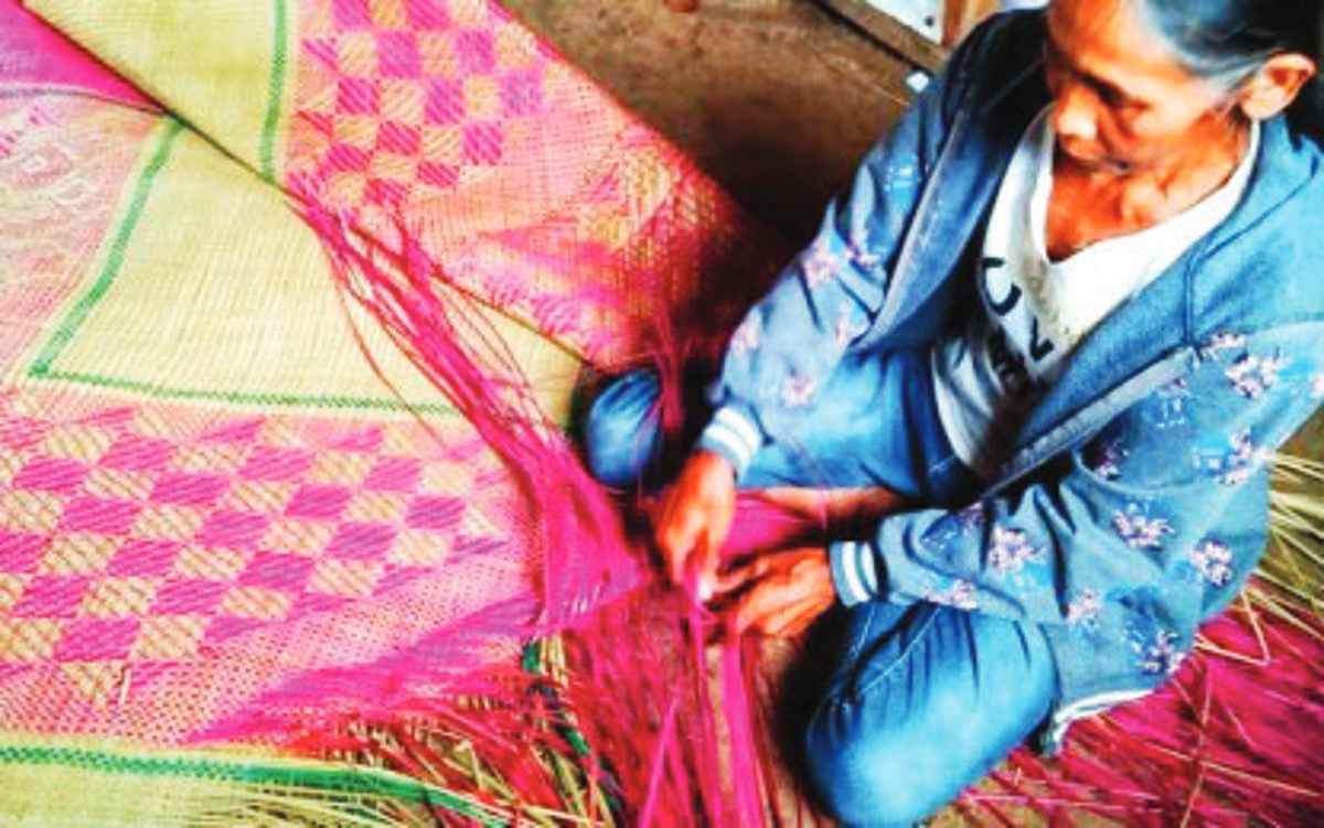 A master weaver of Sitio Madaja in Himamaylan City, Negros Occidental, makes a sleeping mat made of “tikog” (reed grass) in this photo taken in 2022. The remote farming community, once under the influence of communist rebels, is thriving under a new livelihood with the assistance of the Philippine Army and the Association of Negros Producers. (Association of Negros Producers / 94th Infantry Battalion / File photo)