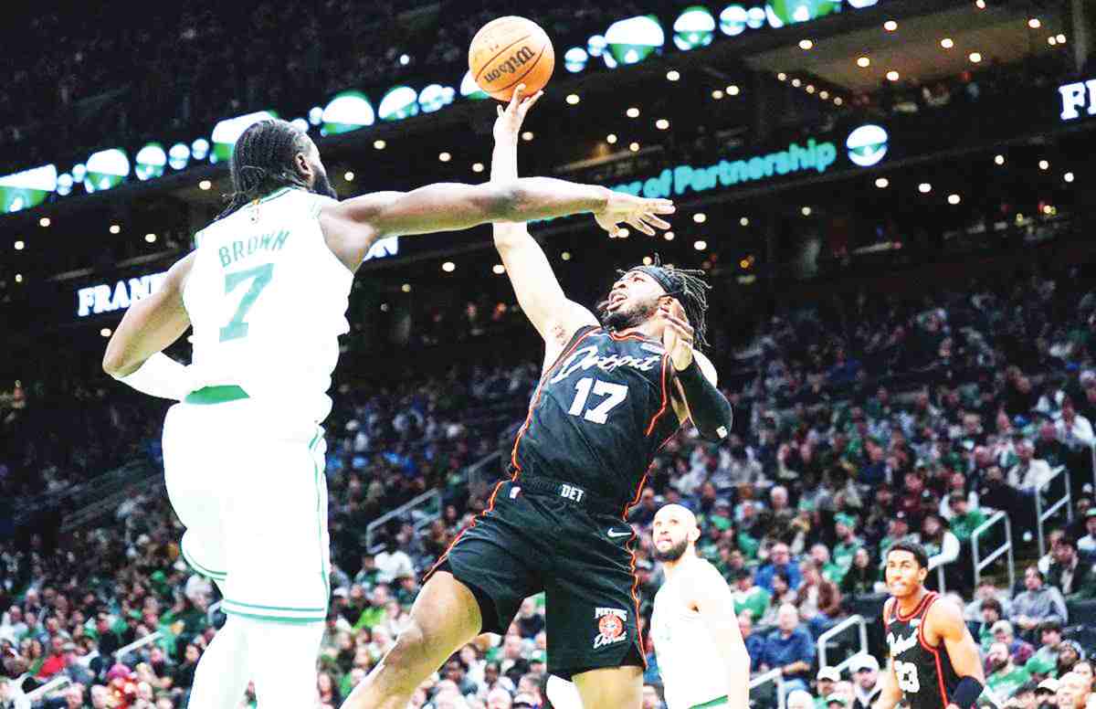 Detroit Pistons guard Stanley Umude (right) shoots against Boston Celtics guard Jaylen Brown in the second half of an NBA game. (David Butler II / Reuters photo)