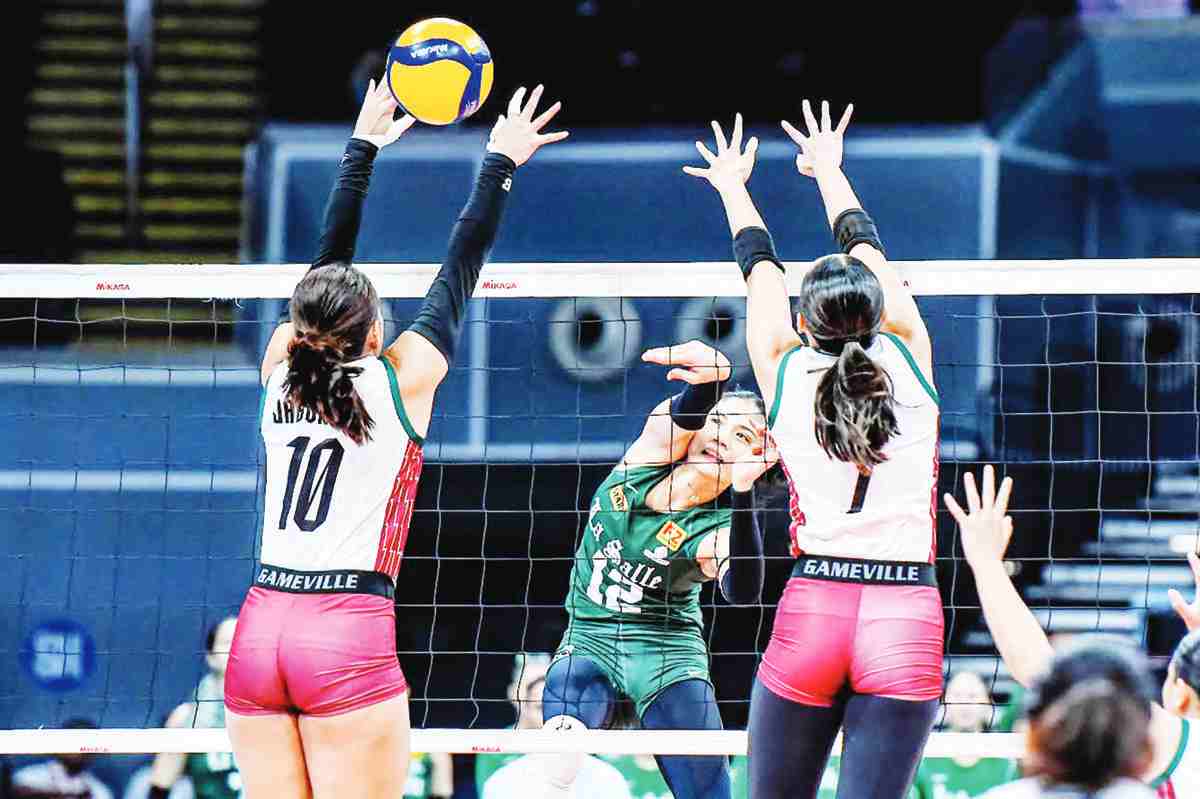 Bacolodnon Angel Canino of De La Salle University Lady Spikers scores against the defense of Antiqueña Irah Jaboneta of the University of the Philippines Fighting Maroons. (UAAP photo)