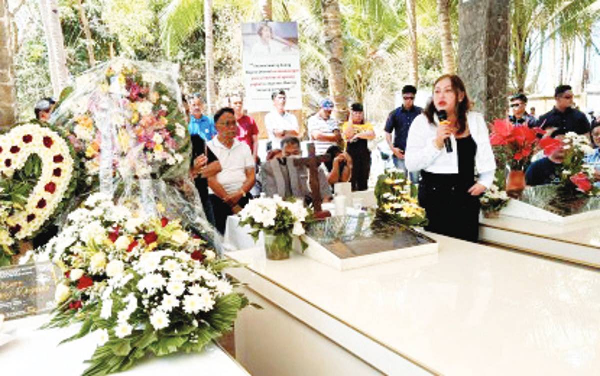 Mayor Janice Degamo of Pamplona, Negros Oriental glances at the tomb of her late husband, former Governor Roel Degamo, during the commemoration of his first death anniversary on Monday, March 4, 2024. During the activity, the so-called Unity Team in Negros Oriental announced the forging of alliances between the Degamo and the Sagarbarria camps. (PNA photo)