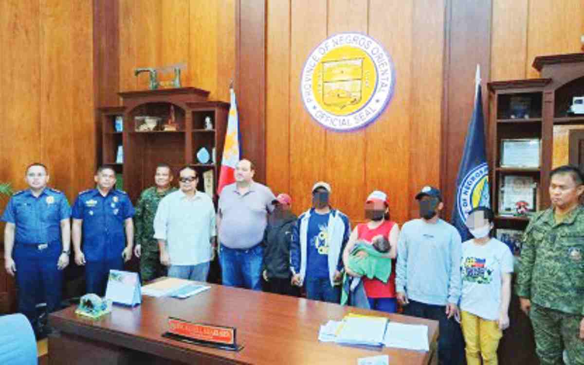 Three former rebels of the New People's Army are presented to Negros Oriental Governor Manuel Sagarbarria on Friday afternoon, April 19, 2024. Two of them surrendered to be with their wives and children. (Contributed photo)