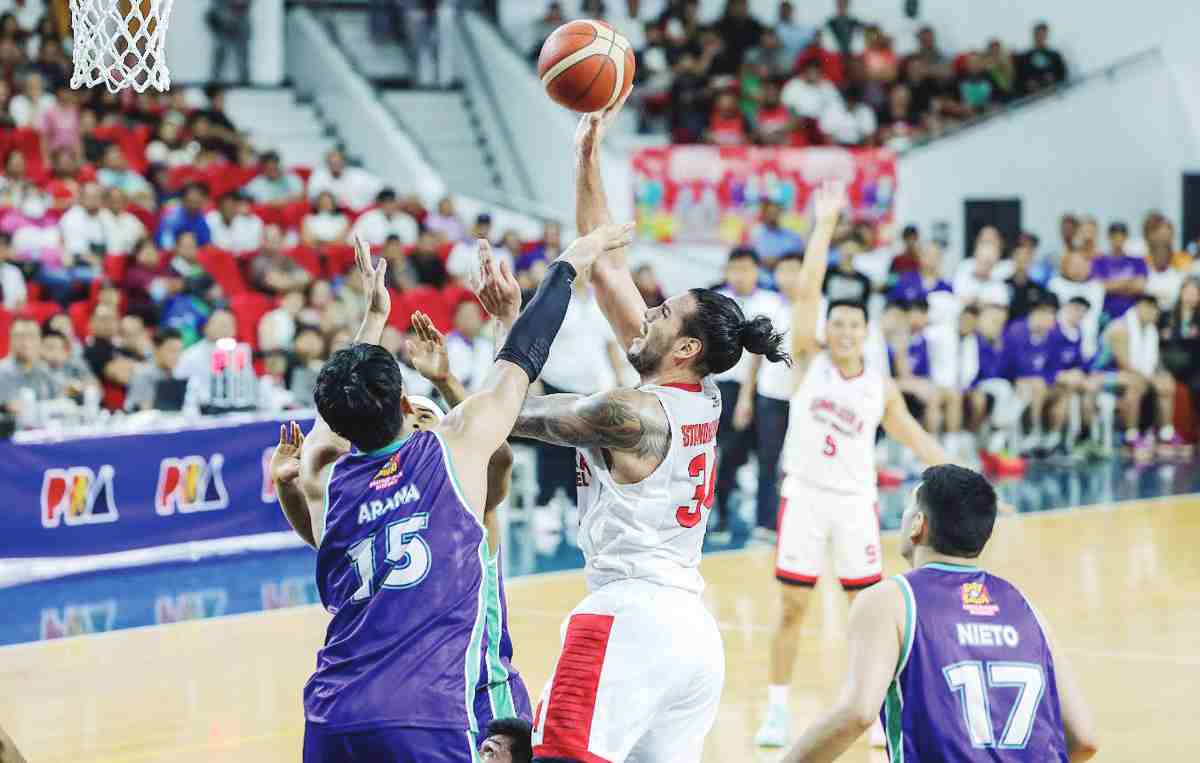 Barangay Ginebra San Miguel Kings’ Christian Standhardinger scores against the defense of Converge FiberXers’ Justin Arana. (PBA photo)