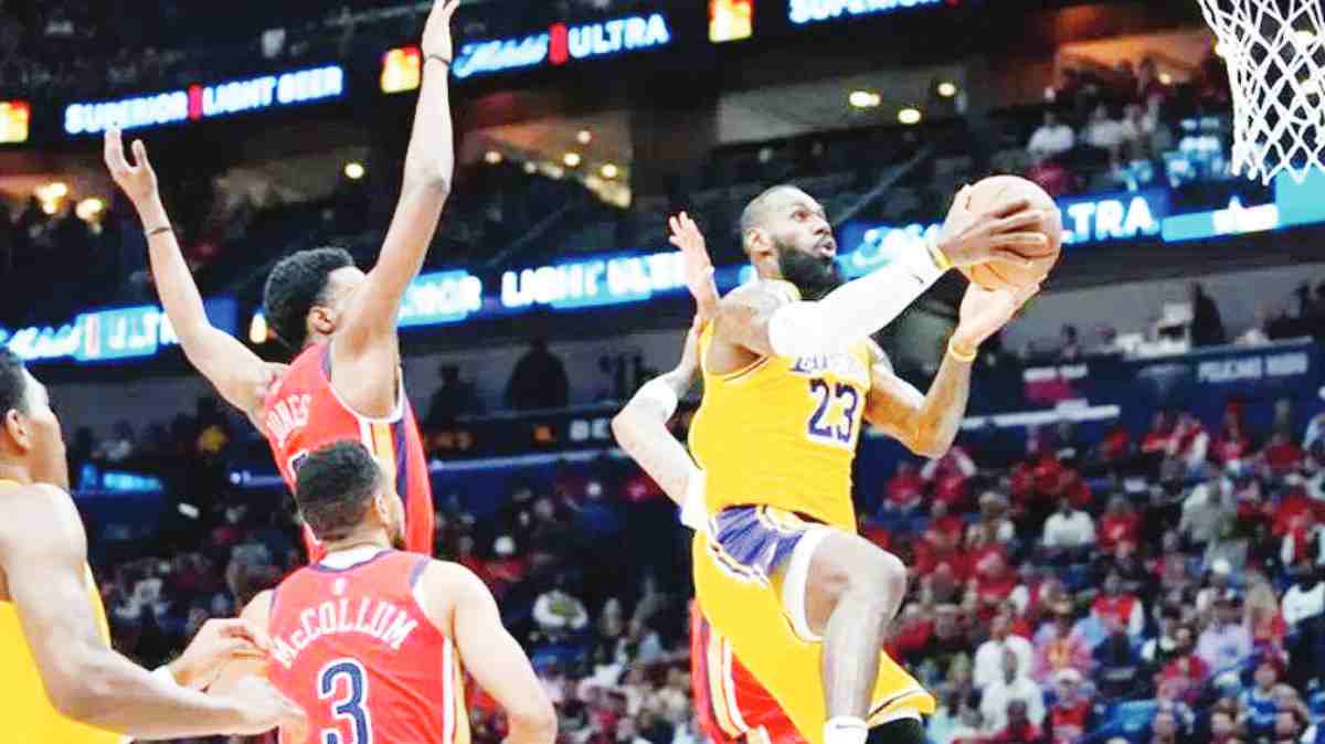 Los Angeles Lakers forward LeBron James (right) goes to the basket in the first half of an NBA play-in tournament game against the New Orleans Pelicans on Tuesday, April 16, 2024. (Gerald Herbert / AP photo)