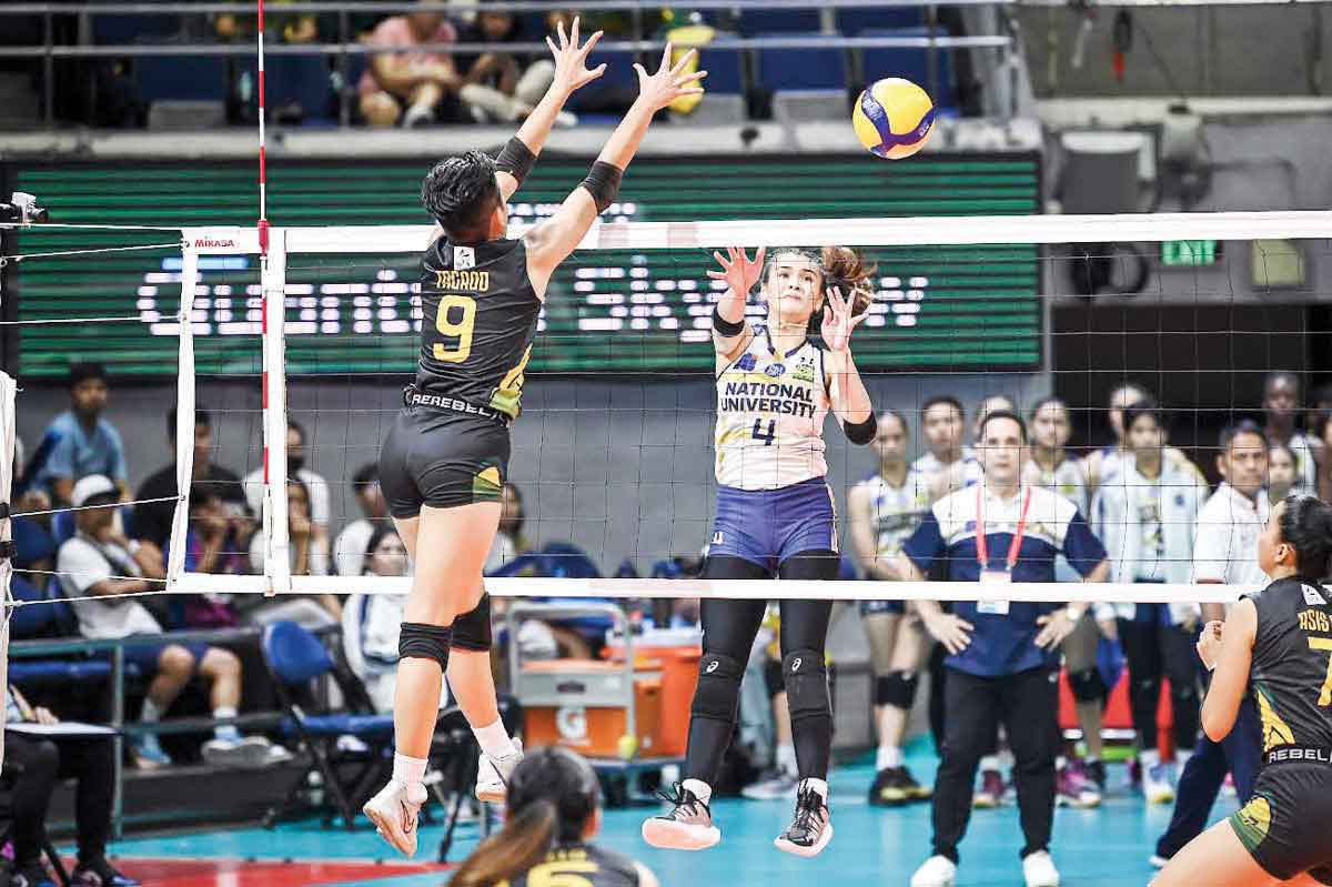 National University Lady Bulldogs’ Mhicaela Belen goes for an attack against Far Eastern University Lady Tamaraws’ Chenie Tagaod. (UAAP photo)