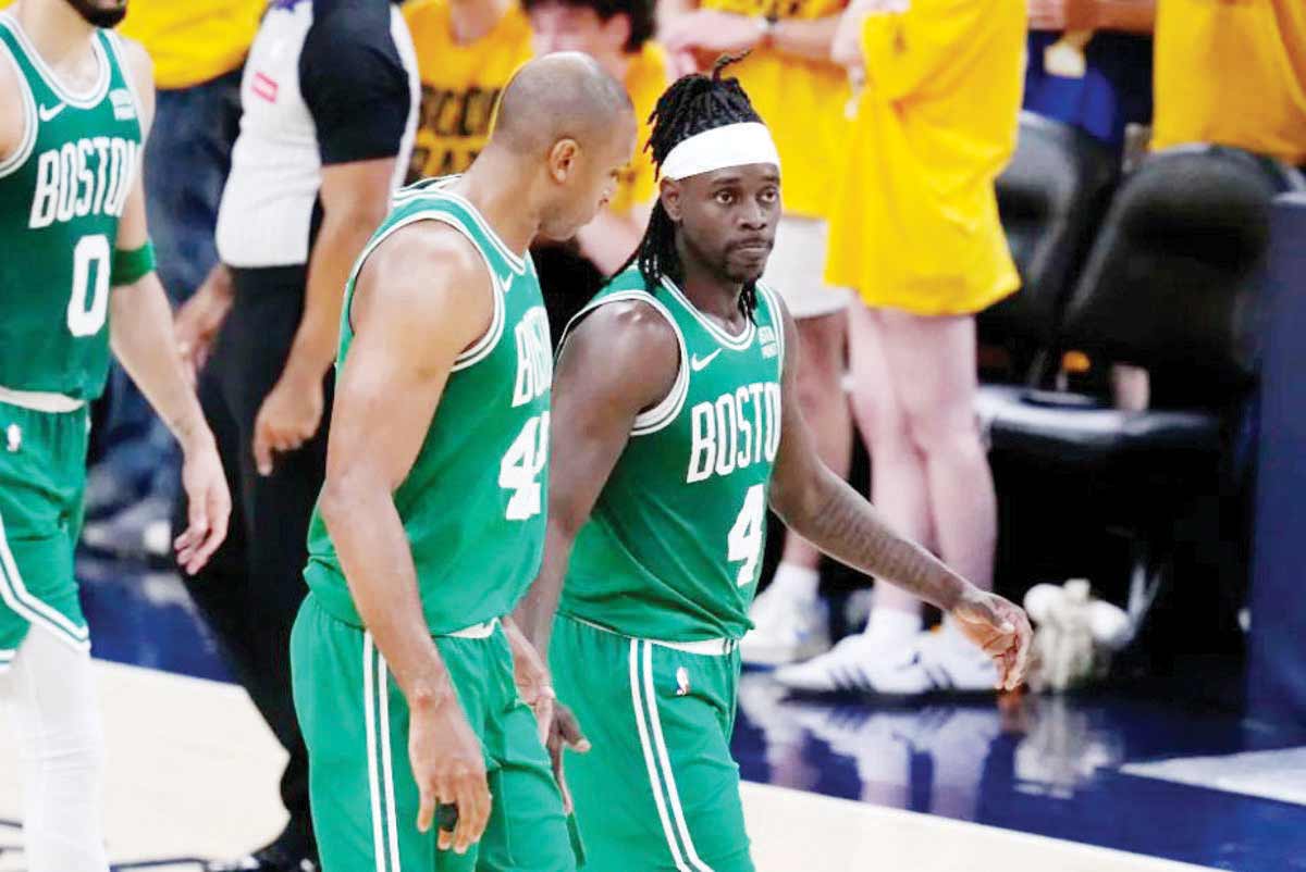 Boston Celtics guard Jrue Holiday (right) walks off the court with teammate Al Horford after Game 3 of the NBA Eastern Conference finals against the Indiana Pacers. (Darron Cummings / AP photo)