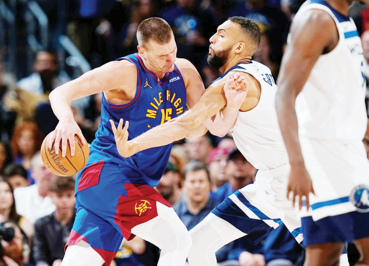 Denver Nuggets center Nikola Jokic (left) drives to the basket as Minnesota Timberwolves center Rudy Gobert defends in Game 1 of an NBA second-round playoff series. (David Zalubowski / AP photo)