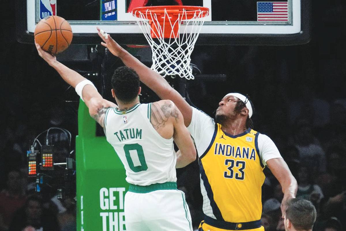 Boston Celtics forward Jayson Tatum (left) puts up a shot against Indiana Pacers center Myles Turner during Game 1 of the NBA Eastern Conference basketball finals. (Charles Krupa / AP photo) 