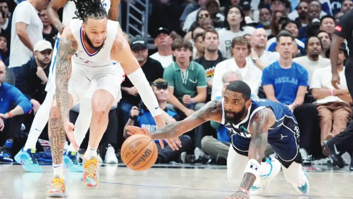 Los Angeles Clippers guard Amir Coffey (left) and Dallas Mavericks guard Kyrie Irving go after a loose ball during Game 5 of an NBA first-round playoff series in Los Angeles. (Mark J. Terrill / AP photo)