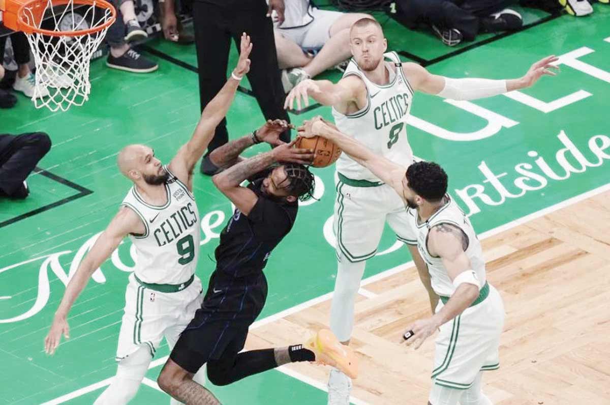 Boston Celtics’ Derrick White (9), Kristaps Porzingis (8) and Jayson Tatum (0) block a shot by Dallas Mavericks’ Derrick Jones, Jr. during the second half of Game 1 of the NBA finals on Friday, June 7, 2024. (Michael Dwyer / AP photo)