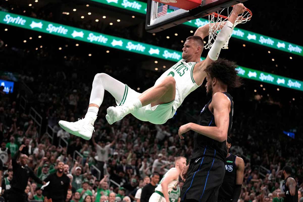 Boston Celtics center Kristaps Porzingis dunks next to Dallas Mavericks center Dereck Lively II during Game 1 of the NBA finals in Boston. (AP photo)