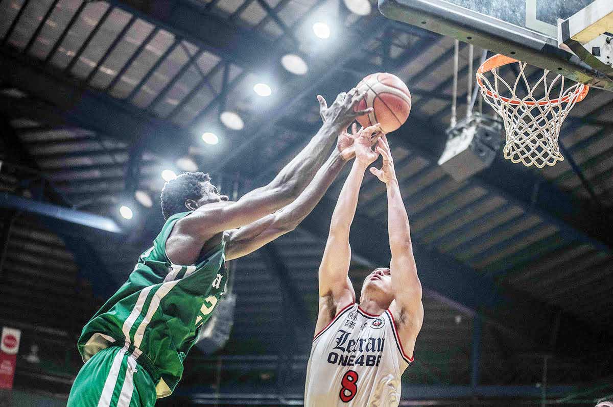 De La Salle University Green Archers’ Henry Agunnane goes for an inside hit against a Colegio de San Juan de Letran Knights defender. (FilOil Sports photo) 