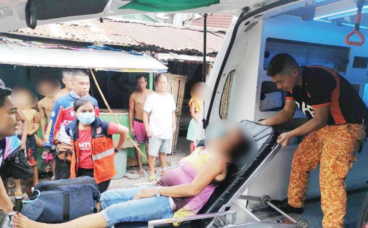 A resident receives assistance following a fire at Purok Santol in Bacolod City’s Barangay Mandalagan on Wednesday, June 5, 2024. (BFP-Bacolod photo)