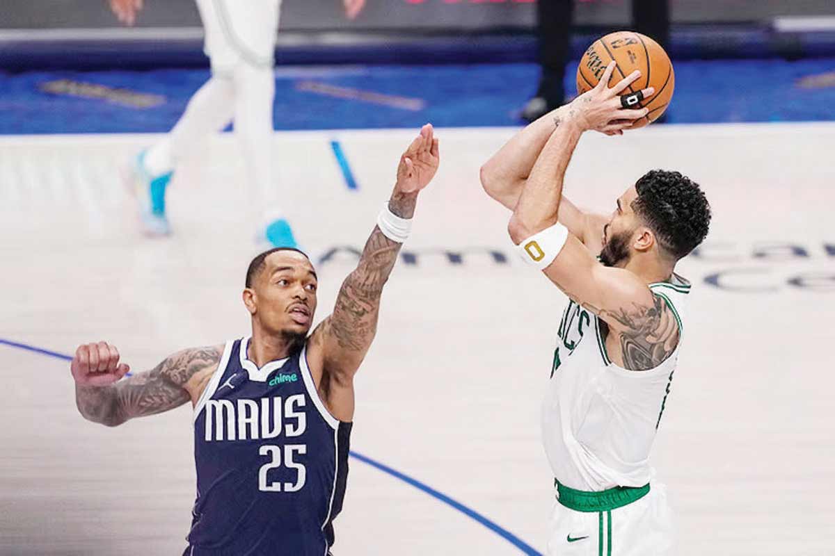 Boston Celtics forward Jayson Tatum (right) shoots against Dallas Mavericks forward P.J. Washington during Game 3 of the NBA finals on Wednesday, June 12, 2024. (Tony Gutierrez / AP photo)