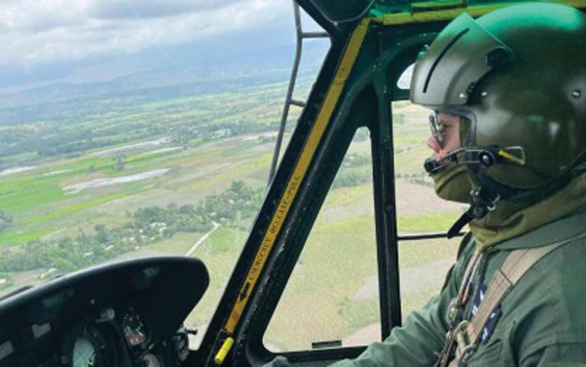 An Air Force helicopter flies over areas affected by Mount Kanlaon's eruption during a rapid damage assessment and needs analysis mission on Tuesday, June 4, 2024. The Philippine Air Force also placed its disaster response team units, fixed-wing aircraft and rotary-wing helicopters on high alert to assist response operations in the aftermath of the volcanic eruption. (PAF photo)