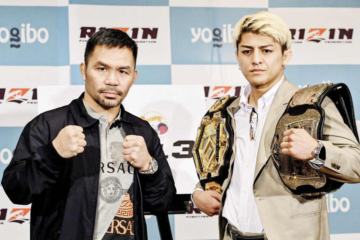 Retired multiple world boxing champion Manny Pacquiao (left) and Japanese kickboxer Chihiro Suzuki pose during a photo session at the end of a press conference at a hotel in Tokyo on Monday, June 10, 2024. Pacquiao will fight Suzuki in a three-round boxing match on July 28 in Saitama, north of Tokyo. (Kazuhiro Nogi / AFP photo)