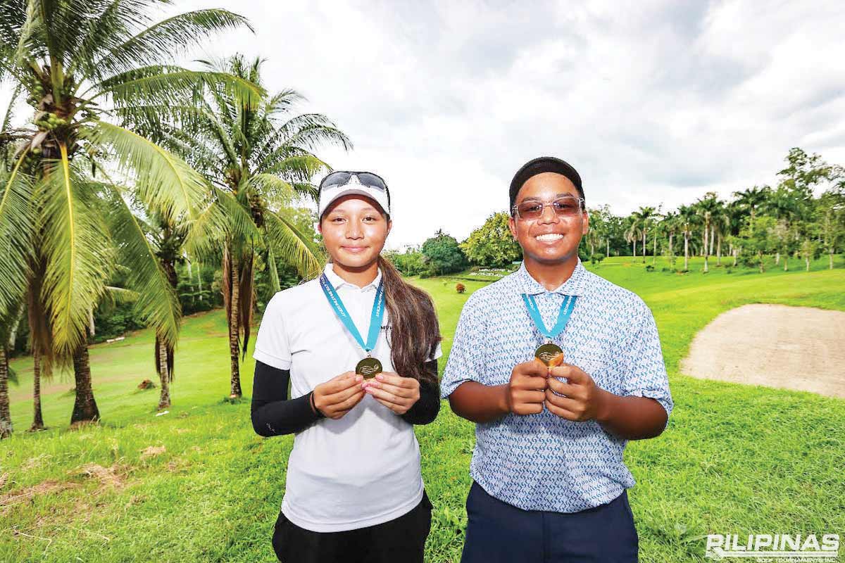 Dominique Gotiong and Patrick Tambalque hold their medals after delivering standout final round performances in their respective age categories in the ICTSI-Junior Philippine Golf Tour Visayas series at the Bacolod Golf and Country Club. (ICTSI photo) 