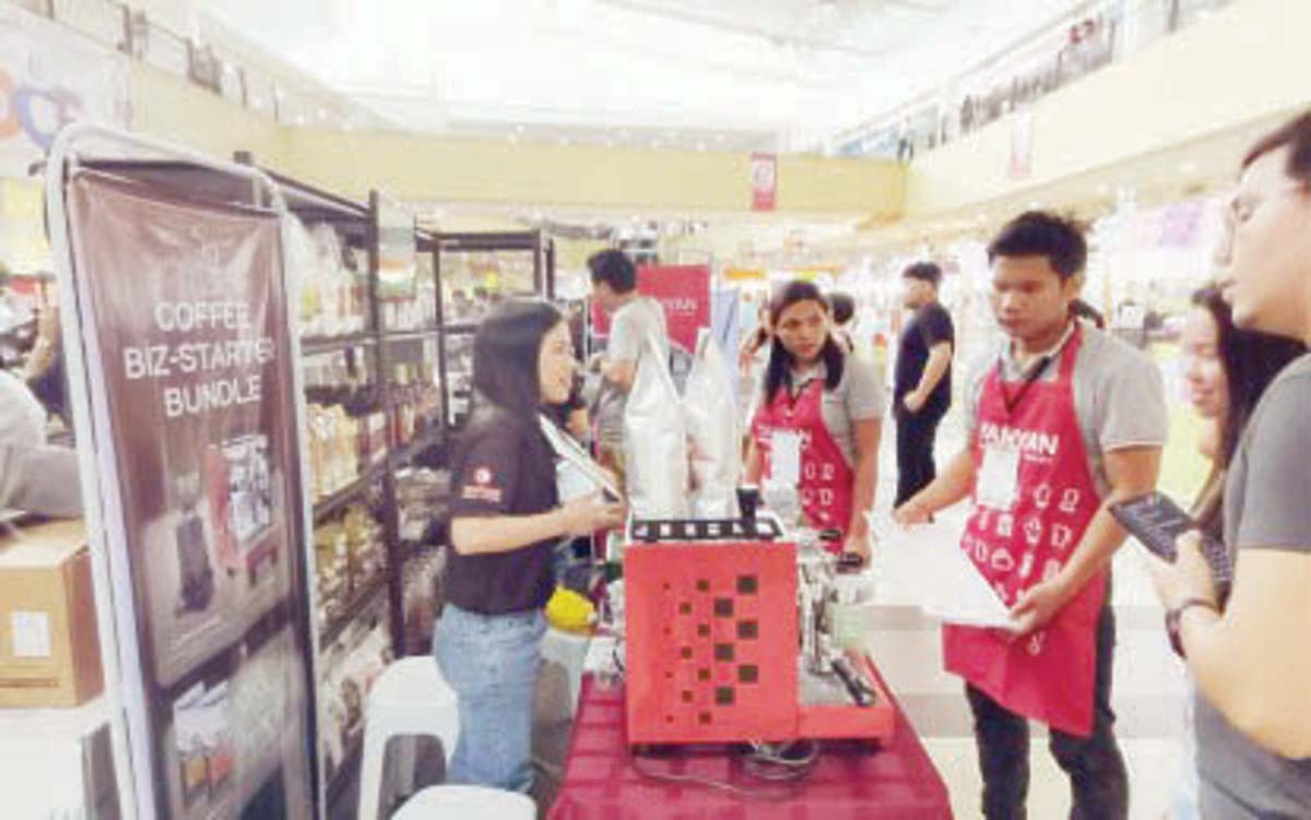 A coffee entrepreneur explains to customers the brand of coffee that they are selling in their outlets. A total of 21 exhibitors are participating in the Dumaguete Coffee Festival at a shopping mall from July 19 to 26, 2024 to help promote Negros Oriental’s coffee industry. (PNA photo)