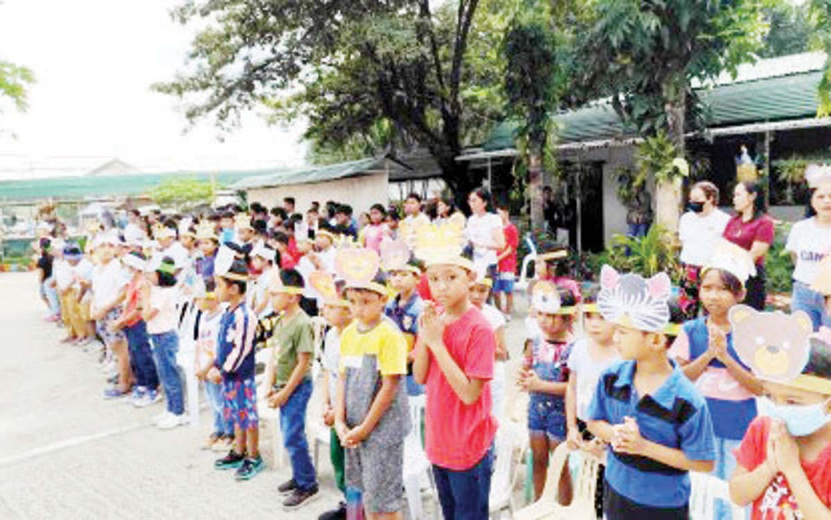 Young learners and teachers gather on the first day of classes of the National Learning Camp at a public elementary school in Dumaguete City, Negros Oriental province on July 2, 2024. The Department of Education in the city said the program aims to boost the proficiency level of some 8,000 enrolled elementary and high school students. (DepEd Dumaguete City Division photo)