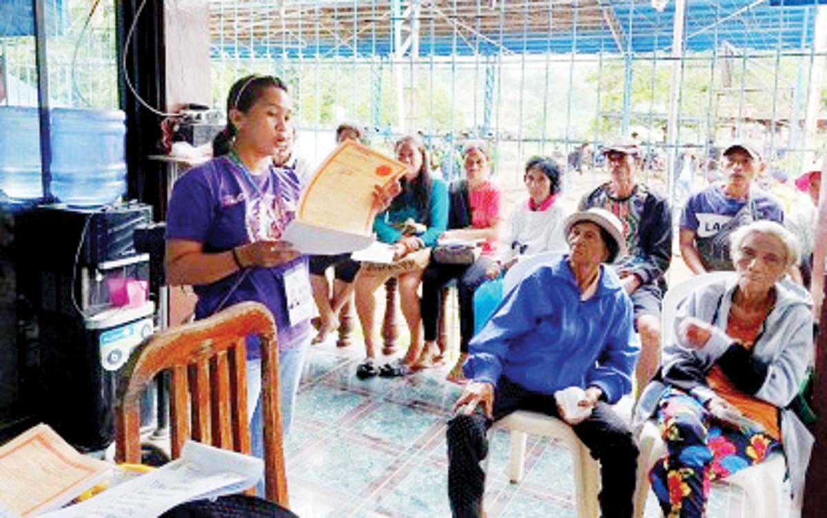 Personnel of the Department of Agrarian Reform Negros Occidental 2 (South) gives an orientation during the distribution of the land titles to 37 farmer-beneficiaries in Moises Padilla, Negros Occidental on Thursday, July 18, 2024. They obtained certificates of land ownership award to the agricultural properties previously owned by three individuals in Barangay Quintin Remo. (DAR Negros Occidental 2 photo)