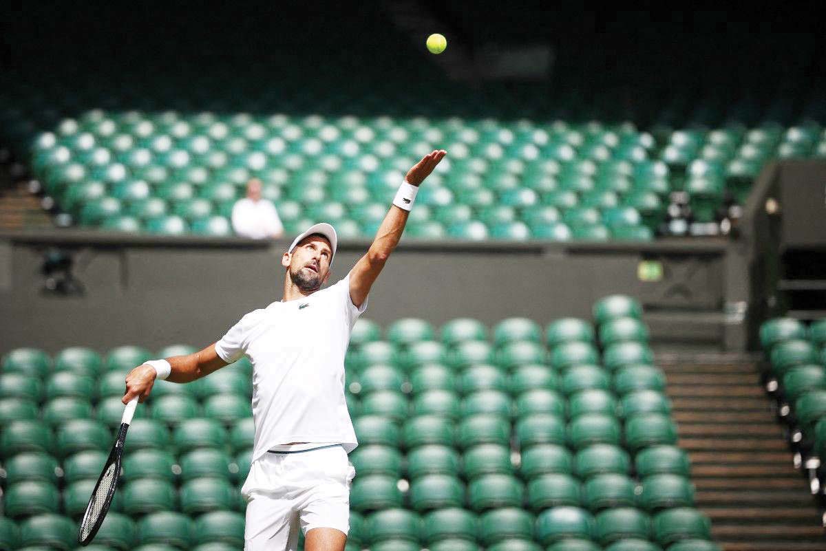 Serbia's Novak Djokovic attends a warm-up session on center court at the All England Lawn Tennis Club in west London on June 27, 2024, a week before the Wimbledon Championships starts. (Henry Nicholls / AFP photo)