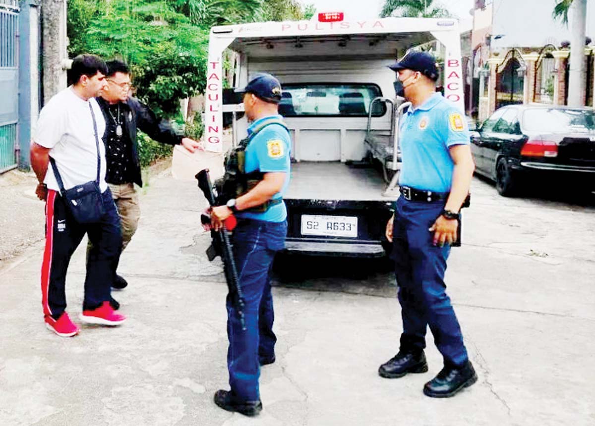 Indian national Joginder Geong was escorted by the arresting authorities in Bacolod City’s Barangay Taculing towards a police service vehicle on Monday, July 8, 2024, following a request from the Indian government for the arrest. (BCPO photo)