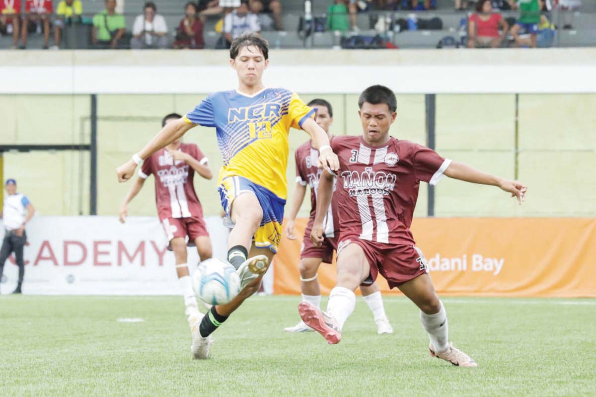 Players from the National Capital Region and Western Visayas battle for the ball during the finals of the 2024 Palarong Pambansa secondary boys’ football tournament. (DepEd Philippines photo)