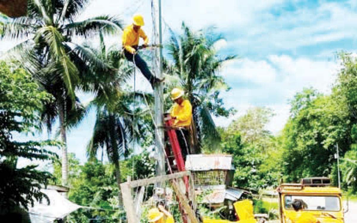 Linemen of Northern Negros Electric Cooperative (Noneco) replace a toppled secondary pole in Toboso town on July 19, 2024. On Monday, July 22, 2024, the Noneco management announced an increase of P6.5625 per kilowatt-hour in average residential power rate for July. (Noneco photo) 