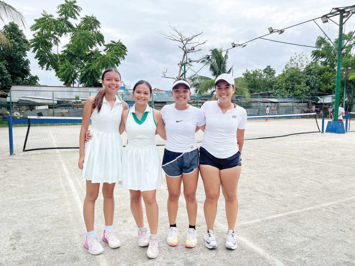 University of St. La Salle-Bacolod’s Mika Ella Medina and Krystel Monique Galanza (third and fourth from left) pose with their Region 7 opponents after their finals match in the tertiary women’s doubles lawn tennis event of the 2024 PRISAA National Games in Legaspi City, Albay. (Leigh Dano photo) 