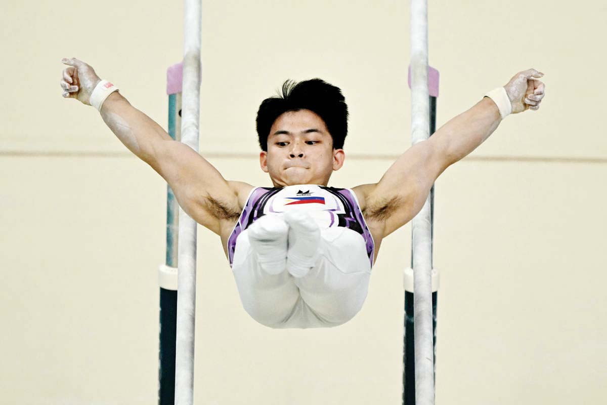 Carlos Edriel Yulo competes in the parallel bars event of the artistic gymnastics men's qualification during the Paris 2024 Olympic Games on Saturday, July 27, 2024. (Lionel Bonaventure / AFP photo)