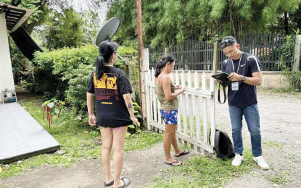 An enumerator of the Philippine Statistics Authority in Negros Oriental gathers data from a household in Dumaguete City in this undated photo. Boundary conflicts have slowed data collection under the Population Census-Community-Based Monitoring System. (PNA / File photo)