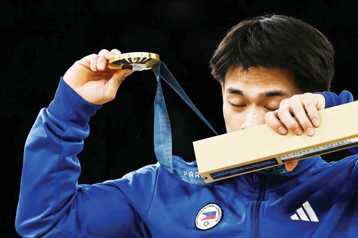 The Philippines' Carlos Edriel Yulo reacts as he celebrates during the podium ceremony after competing in the artistic gymnastics men's floor exercise final in the 2024 Paris Olympic Games at the Bercy Arena on Saturday, August 3, 2024. (Paul Ellis / AFP photo)