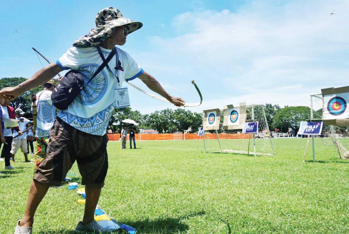 Around 350 members of indigenous peoples (IPs) from 17 local government units in Negros Occidental compete in the IP Games Visayas Leg in Bago City over the weekend. The IPs compete in pana, bangkaw, fire-making, trumpo, panit-lubi, kadang, palo sebo, tumba-patis, bayo gisig, and galing mais. (Andrew Altarejos photo)