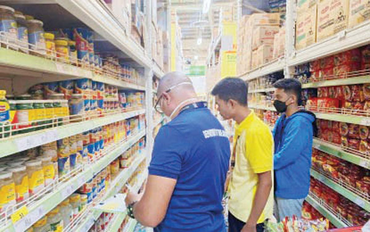 Personnel from the Department of Trade and Industry in Negros Oriental inspect a major retail establishment in capital, Dumaguete City, in this undated photo. The agency is now conducting weekly price monitoring of noche buena products in anticipation of the holiday rush. (DTI-Negros Oriental photo)