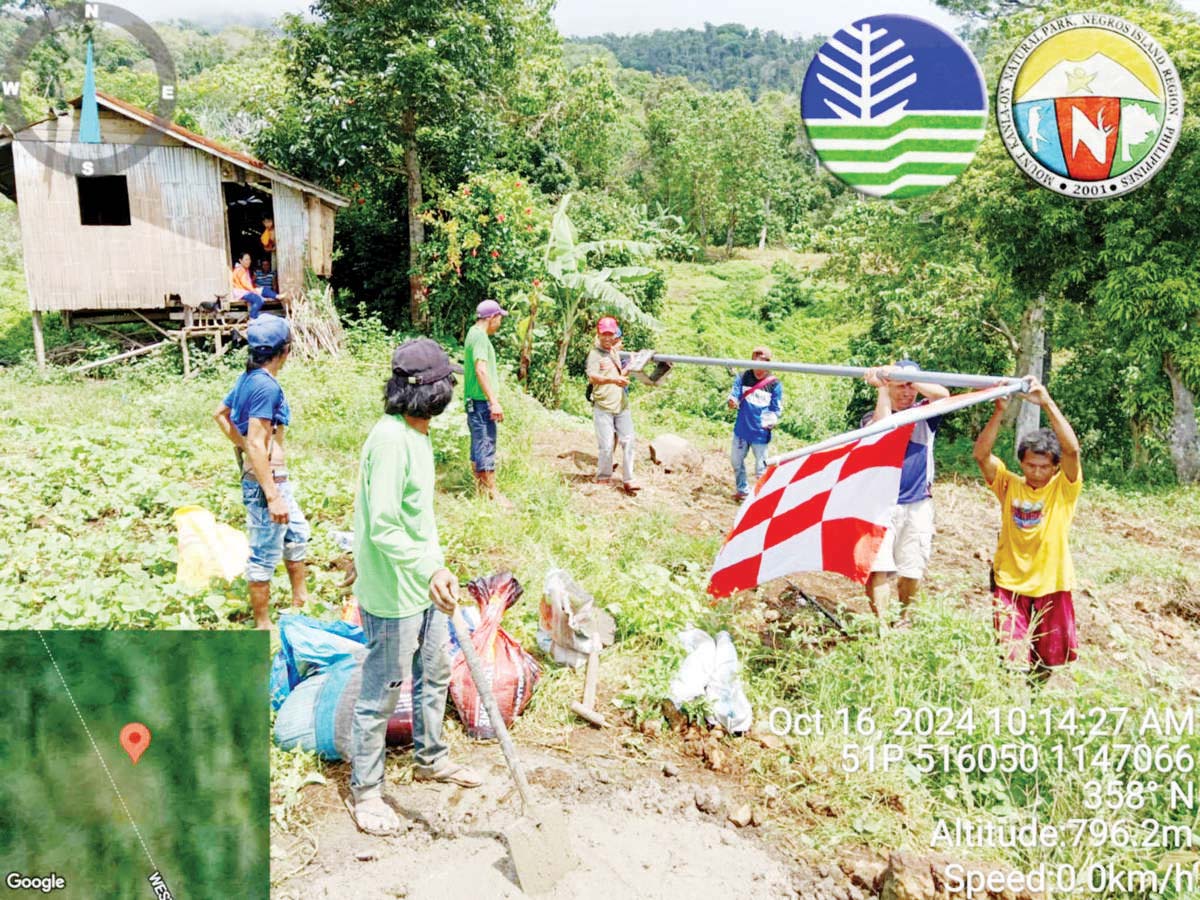 Photo shows the first flag marking the four-kilometer permanent danger zone around Kanlaon Volcano was installed at Barangay Biak na Bato in Negros Occidental’s La Castellana town on October 16, 2024. (PENRO-Negros Occidental photo)