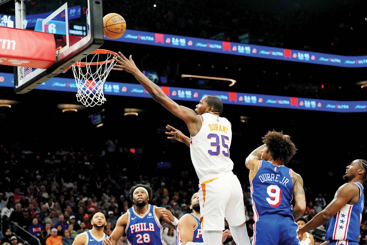 Phoenix Suns forward Kevin Durant puts up a layup over Philadelphia 76ers guard Kelly Oubre, Jr. during the first half of an NBA game. (Joe Camporeale-Imagn Images / Reuters photo)