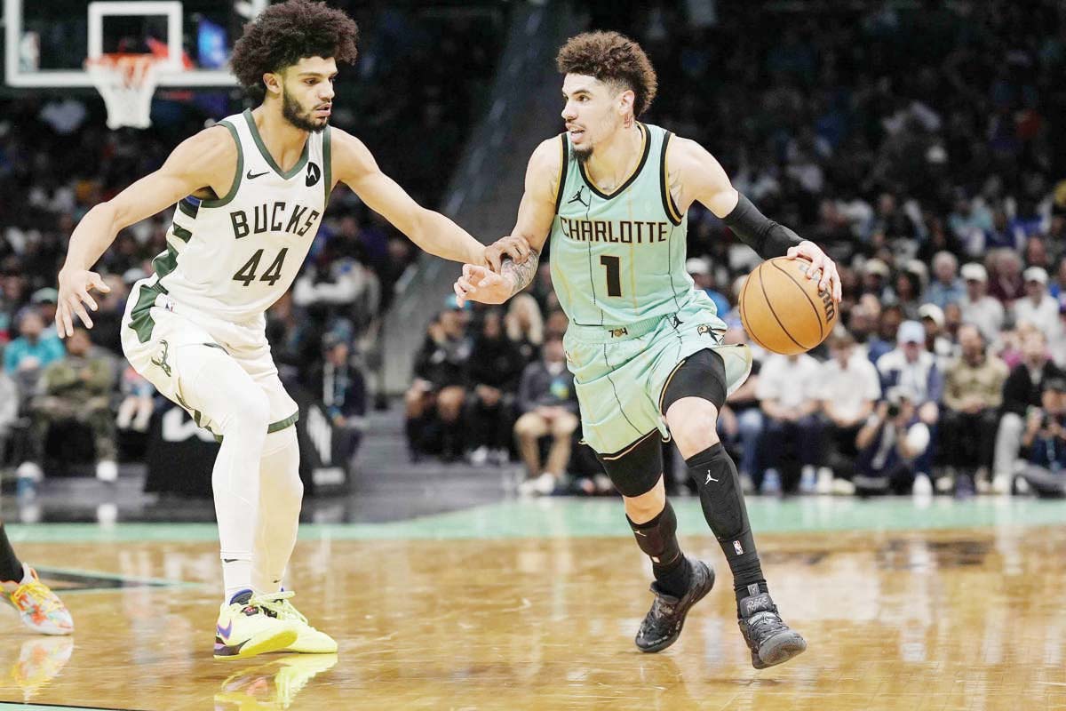 Charlotte Hornets guard LaMelo Ball (right) handles the ball against Milwaukee Bucks guard Andre Jackson, Jr. during the second half of an NBA game. (Jim Dedmon-Imagn Images / Reuters photo)