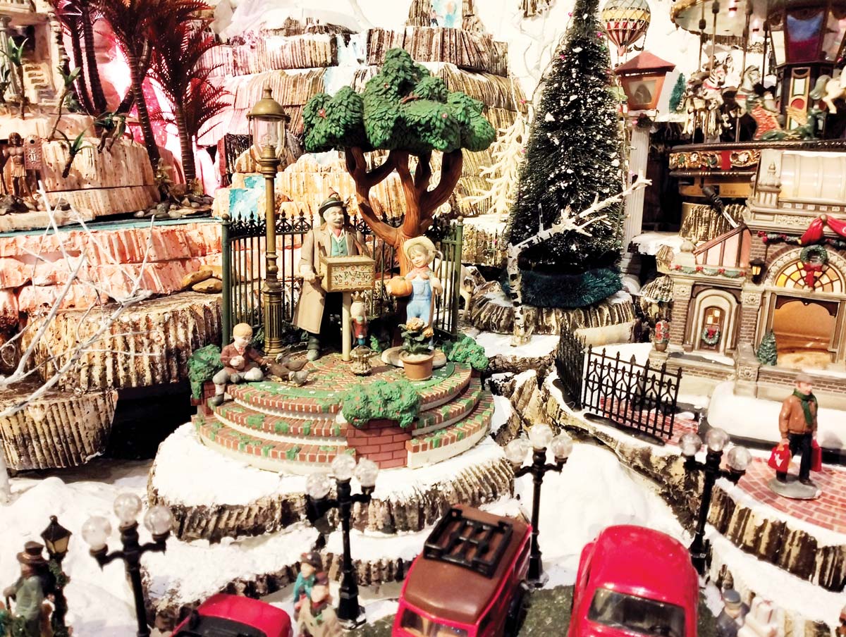 The Christmas village features various themed sections, a mix of moving and stationary elements, meticulously crafted over the years.