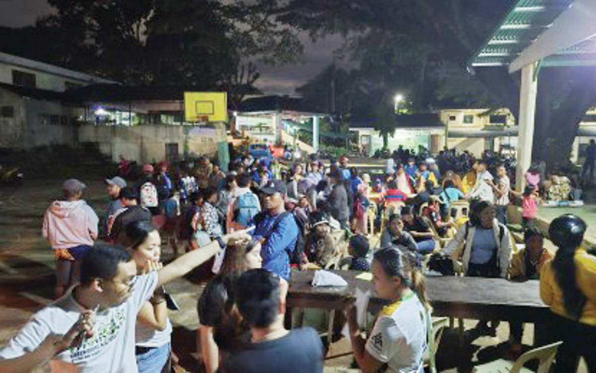 Scores of residents from high-risk barangays in Canlaon City, Negros Oriental arrive at evacuation centers on Sunday evening, December 15, 2024. The Commission on Elections-Negros Island Region says it is prepared for a potential postponement of the May 2025 elections if a "major eruption" of Mt. Kanlaon will happen in the coming months. (Canlaon City PIO photo)