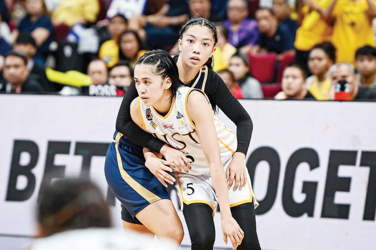 Negrense Kent Jane Pastrana of the University of Santo Tomas Growling Tigresses is being defended by National University Lady Bulldogs’ Camille Clarin. (UAAP photo)