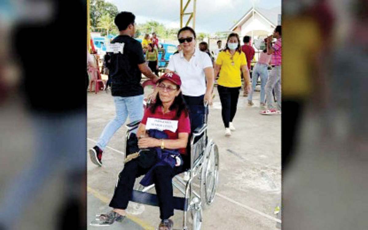 A camp manager assists a person with disability during an Alert Level 4 evacuation simulation in Canlaon City, Negros Oriental on Thursday, January 9, 2024. The exercise was part of training for over 100 newly-appointed camp managers, aimed at bolstering evacuation protocols following the December 9 eruption of Mt. Kanlaon. (SALTA Canlaon Official photo)