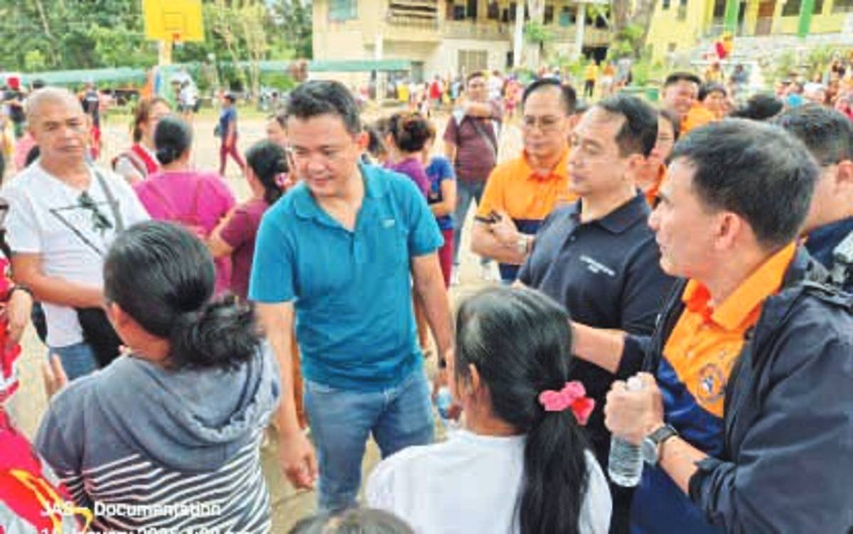 Mayor Jose Chubasco Cardenas of Canlaon City, Negros Oriental with Office of Civil Defense officials during a talk with internally displaced persons at an evacuation center on January 15, 2025. The mayor said the city government welcomes inquiries regarding the use of funds and donations relative to its disaster response following the December 9, 2024 eruption of Mt. Kanlaon. (Canlaon City Public Information Office photo)