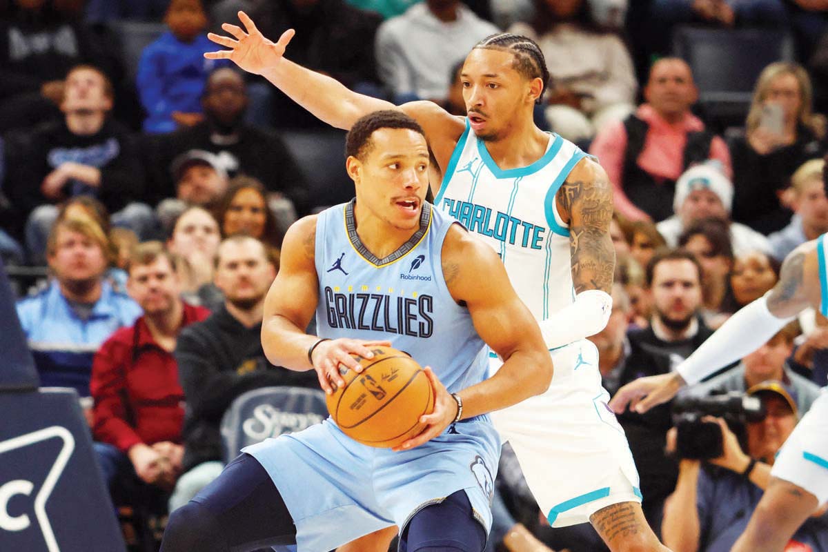 Memphis Grizzlies guard Desmond Bane (front) spins toward the basket as Charlotte Hornets guard Nick Smith, Jr. defends. (Petre Thomas-Imagn Images)