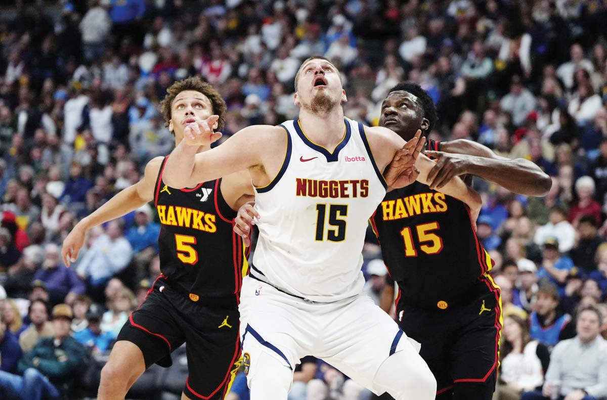 Atlanta Hawks guard Dyson Daniels (left), center Clint Capela (right) and Denver Nuggets center Nikola Jokic look on the ball during the second quarter of an NBA game. (Ron Chenoy-Imagn Images / Reuters photo)