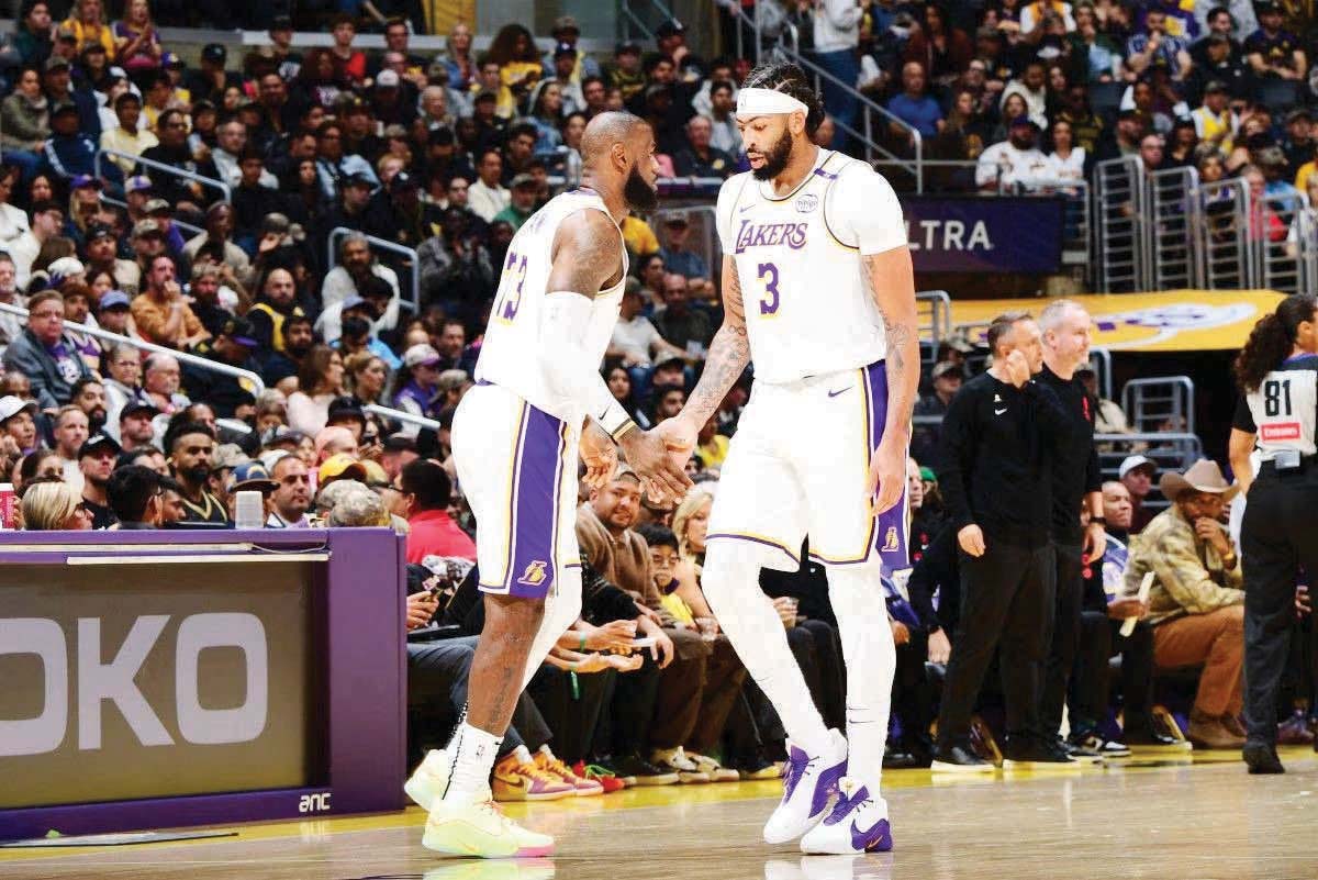 LeBron James (left) and Anthony Davis of the Los Angeles Lakers high five during the game against the Boston Celtics. (Adam Pantozzi / NBAE via Getty Images / AFP photo)