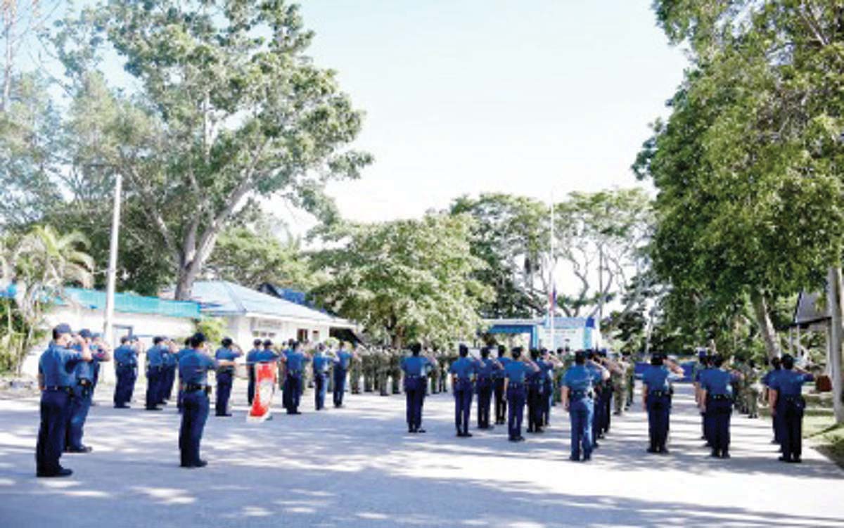 Officers of the Negros Oriental Police Provincial Office (NOPPO) salute the Philippine flag in this undated photo. NOPPO will recall security details for government officials and private citizens at the start of the election period on January 12, 2025. (PNA / File photo)