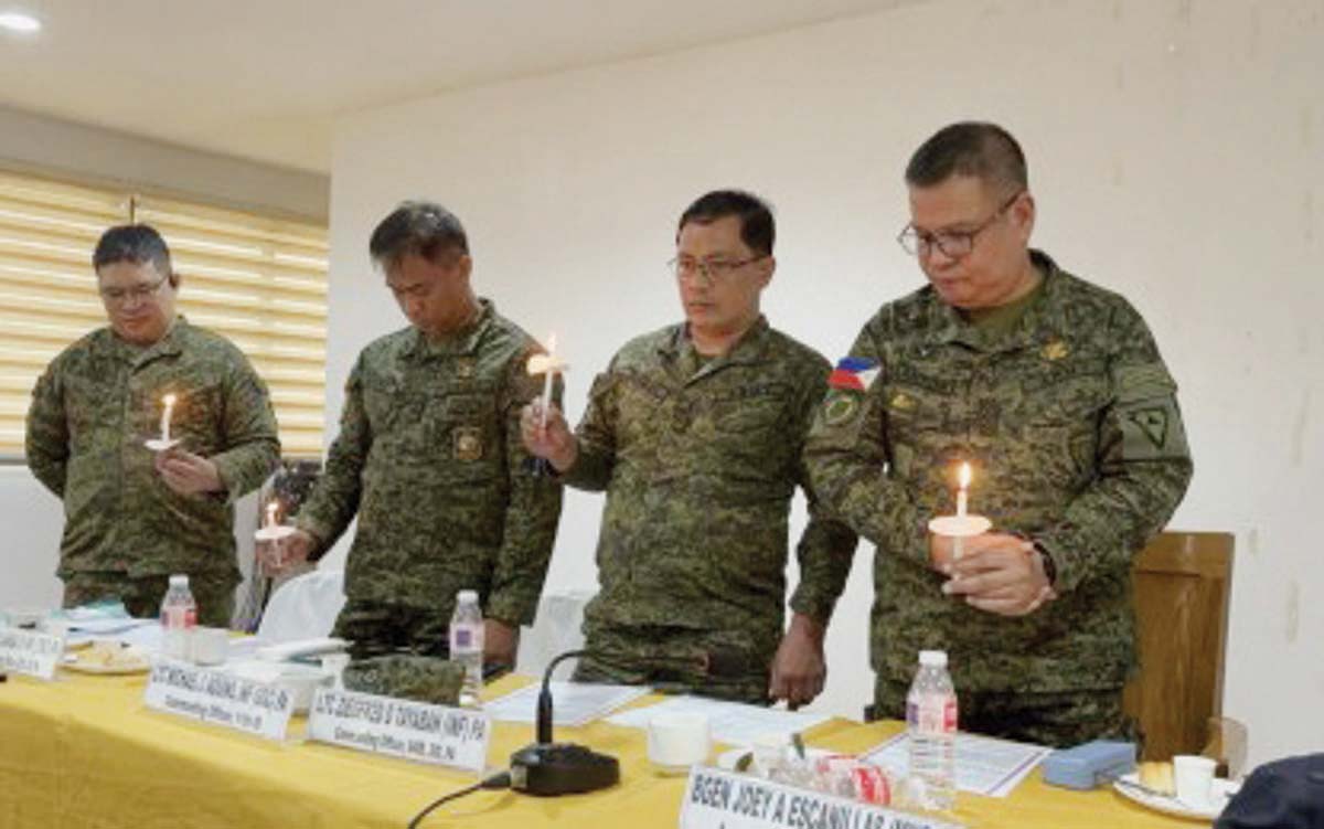 Ranking officials of the Philippine Army in Negros light candles for peace during a covenant signing and interfaith prayer rally at the Negros Oriental Police Provincial Office headquarters in Camp Lt. Colonel Francisco Fernandez Jr., Agan-an, Sibulan town on Friday, February 7, 2025. They assured the public that Army units are still actively securing their areas of coverage against any kind of threat that would mar the May 2025 elections. (PNA photo)