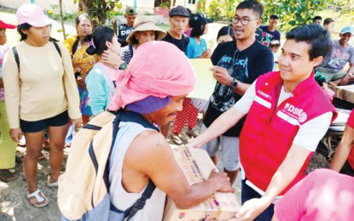 Personnel of the Department of Social Welfare and Development (DSWD) distribute family food packs to residents affected by the eruption of Mt. Kanlaon in Barangay Cabagna-an in La Castellana town, Negros Occidental province in this undated photo. As of February 18, 2025, the DSWD has extended P94.861 million in humanitarian assistance to internally displaced persons in Negros Island since the volcanic eruption on December 9, 2024. (DSWD-Western Visayas photo)