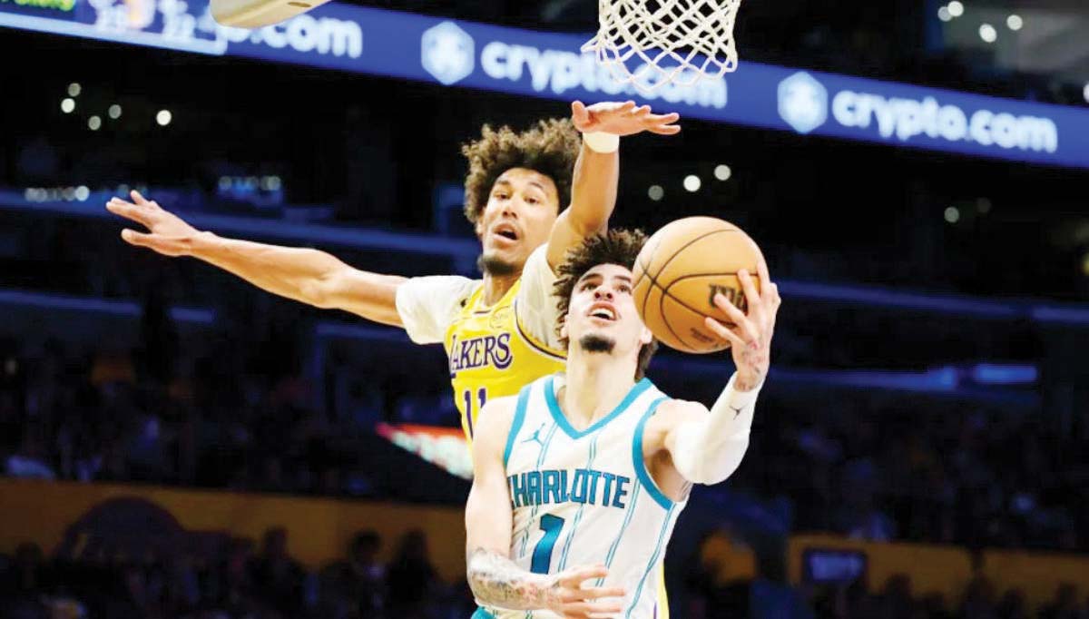 Charlotte Hornets guard LaMelo Ball (1) shoots the ball while under pressure from Los Angeles Lakers center Jaxson Hayes. (William Liang / AP photo)