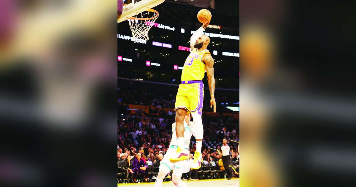 Los Angeles Lakers forward LeBron James dunks against Charlotte Hornets guard LaMelo Ball in the NBA. (Jason Parkhurst-Imagn Images / Reuters photo)